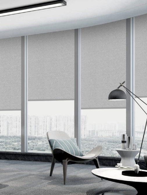 Screen roller shades in an office with a city view